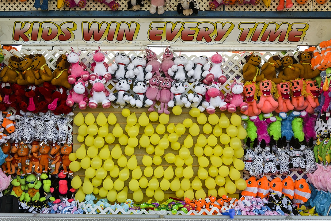 The promise of prizes to be won at a game in the midway.