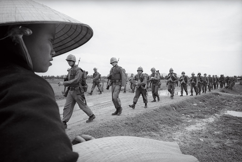Among the images featured in the new documentary The Vietnam War is this 1965 AP photo of Marines marching toward defense positions near Da Nang Air Base.