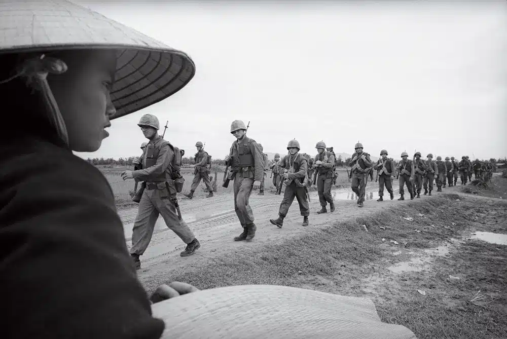 Among the images featured in the new documentary The Vietnam War is this 1965 AP photo of Marines marching toward defense positions near Da Nang Air Base.