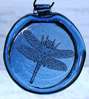 blue glass decoration with a dragonfly design