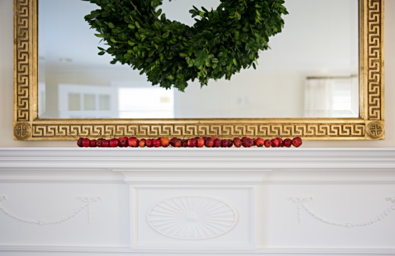 A simple row of crabapples on the mantel adds a lovely pop of color.