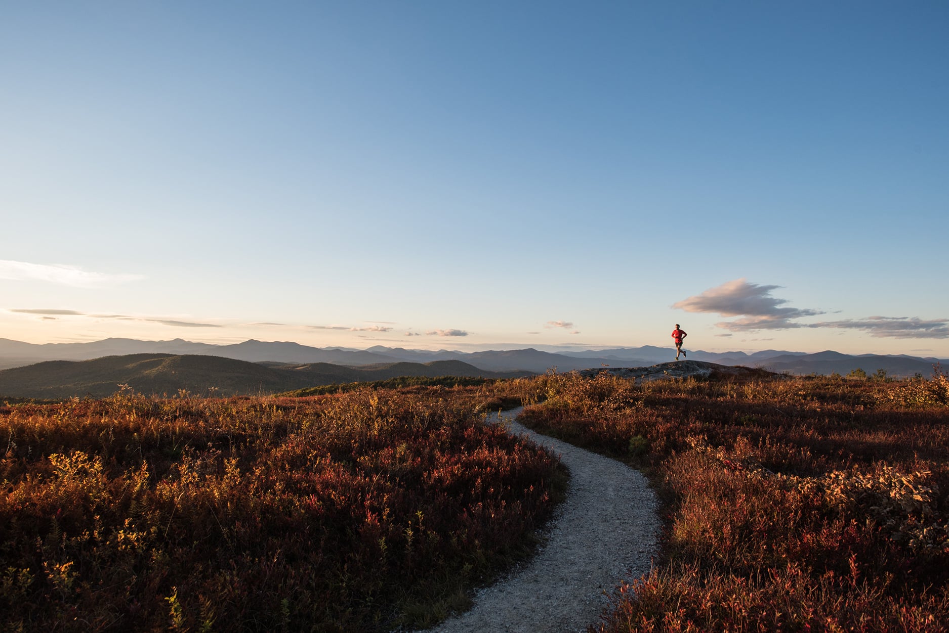 Kevin Tilton trail running in late day light on Foss Mountain.