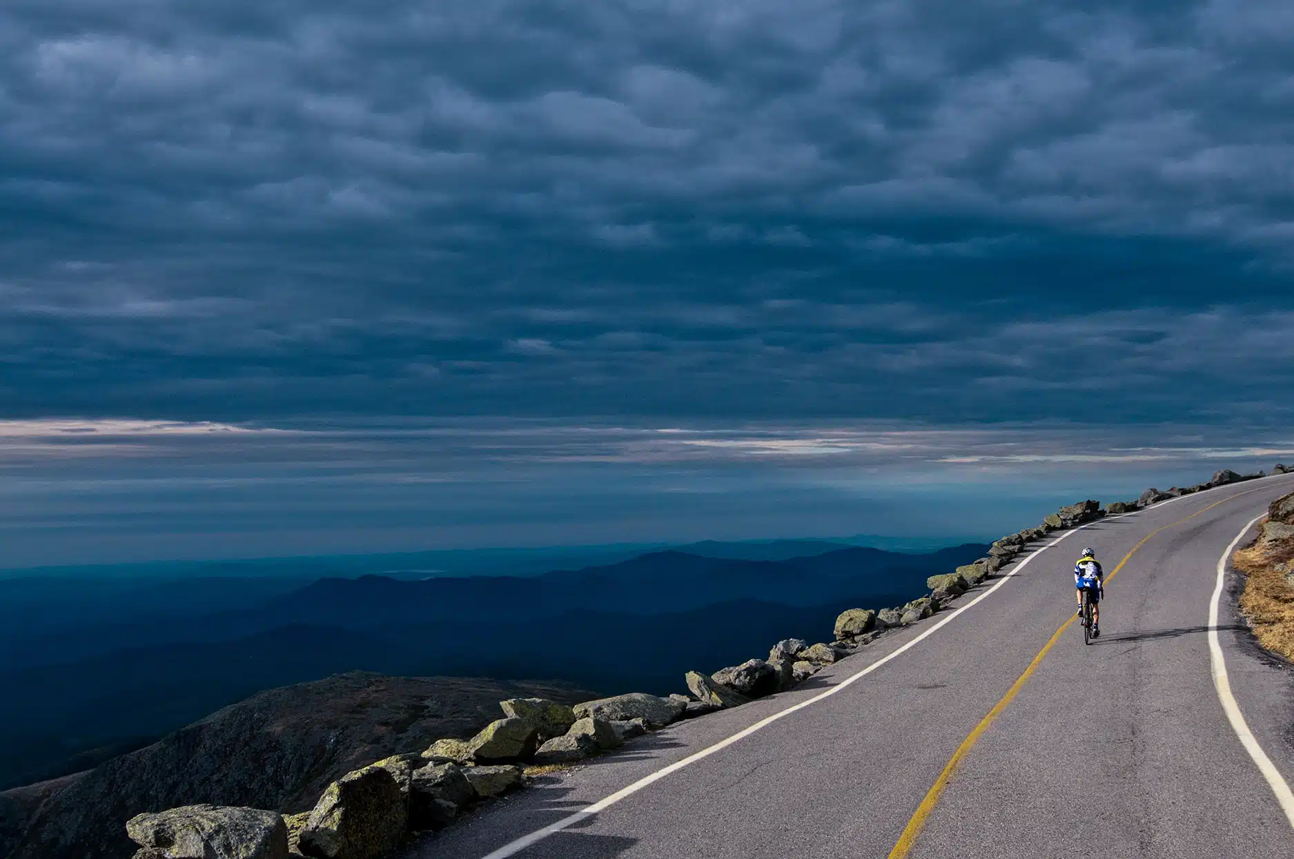 A cyclist along the auto road near the summit of Mount Washington.
