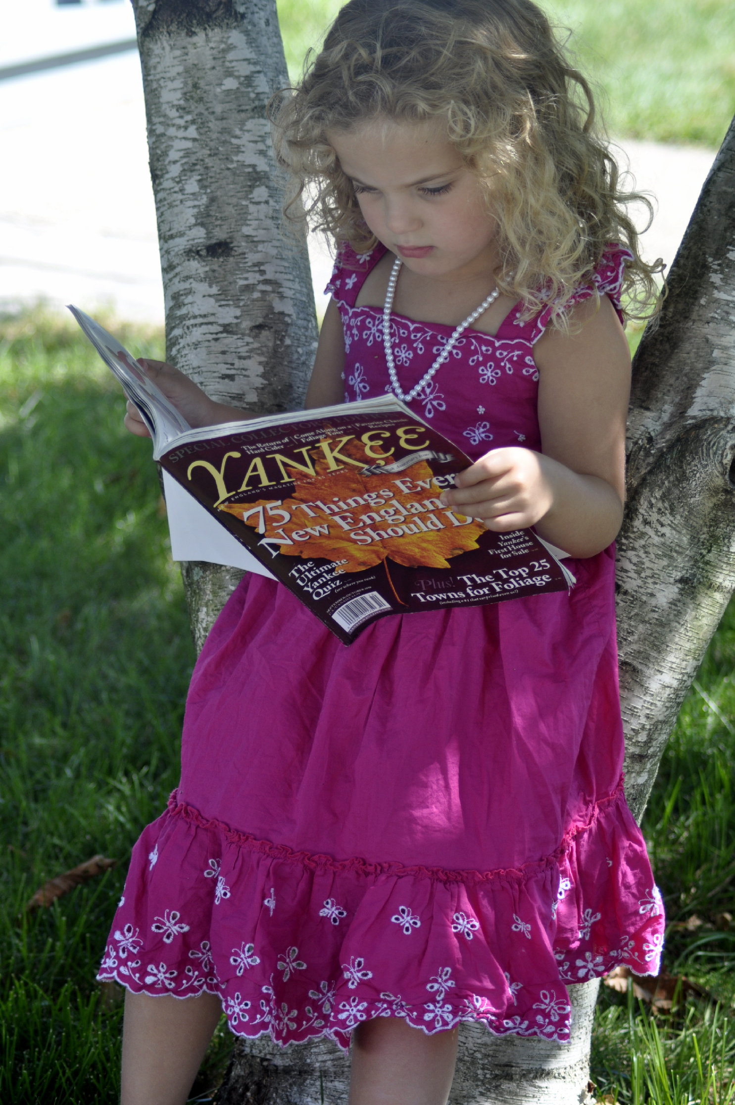 Little Girl Reading Yankee (user submitted)