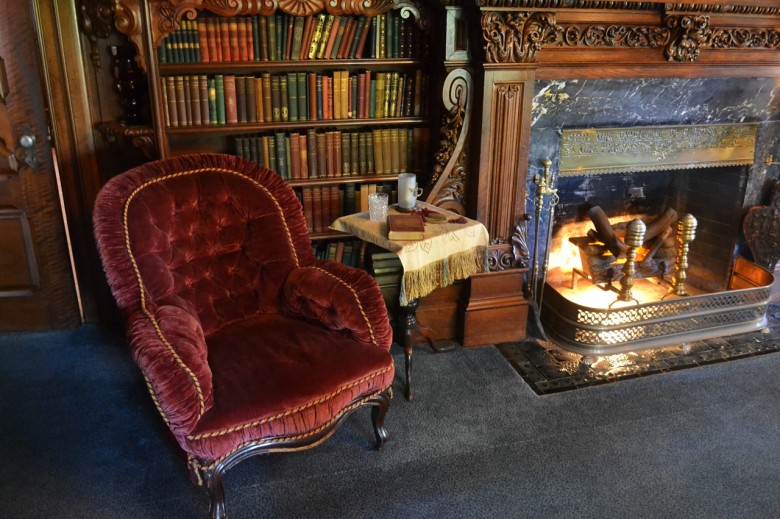 But first, pause to admire the cozy reading chair in front of the fire. The library was considered "the social center of the house."