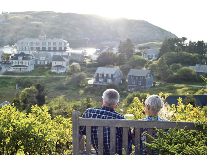 After touring Monhegan’s 19th-century lighthouse, a couple watches the sun setting over Manana Island.