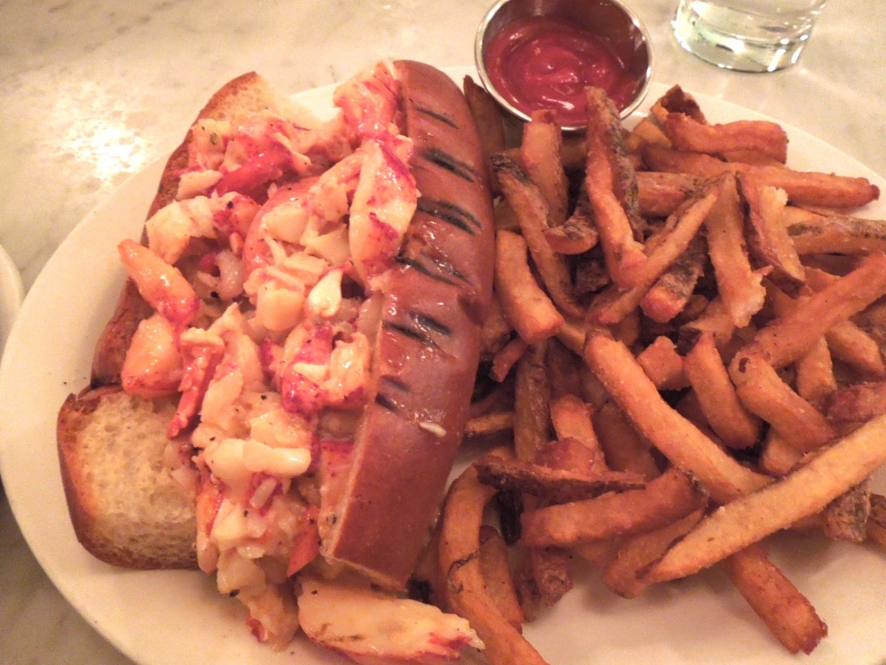 Neptune Oyster Bars warm, buttered lobster roll is often named the best lobster roll in Boston.