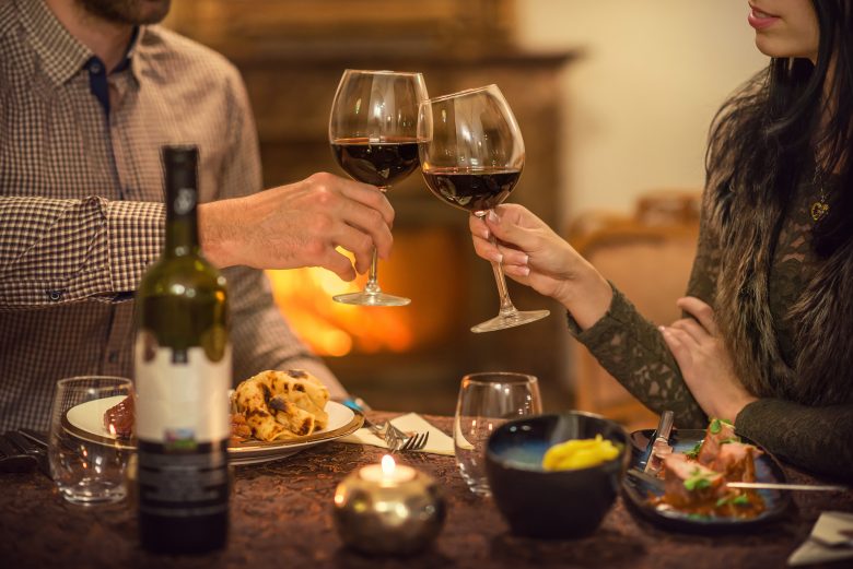 red wine toast in cozy restaurant