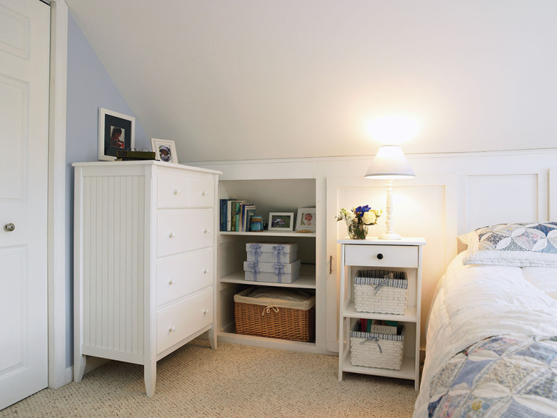 Books, photos, and baskets find a cozy place in this under-eave nook.